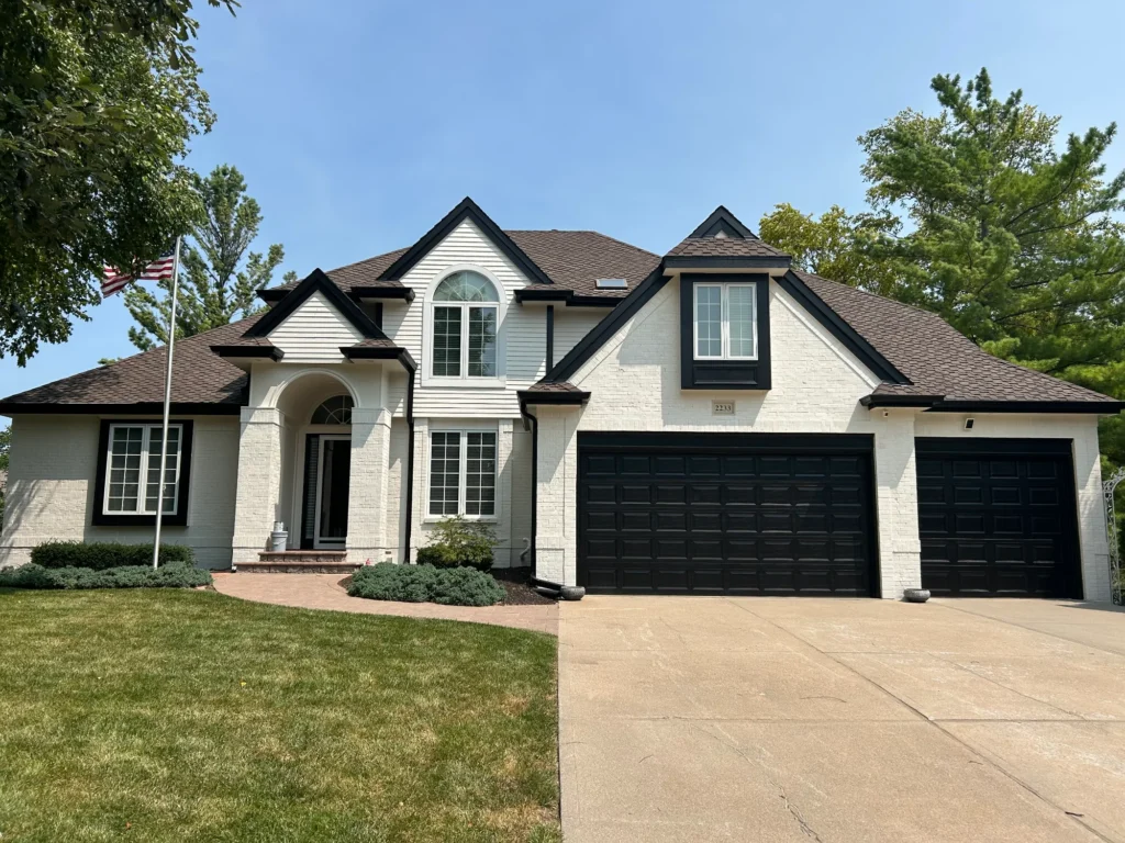 Painted black garage doors and trim on an Omaha area home